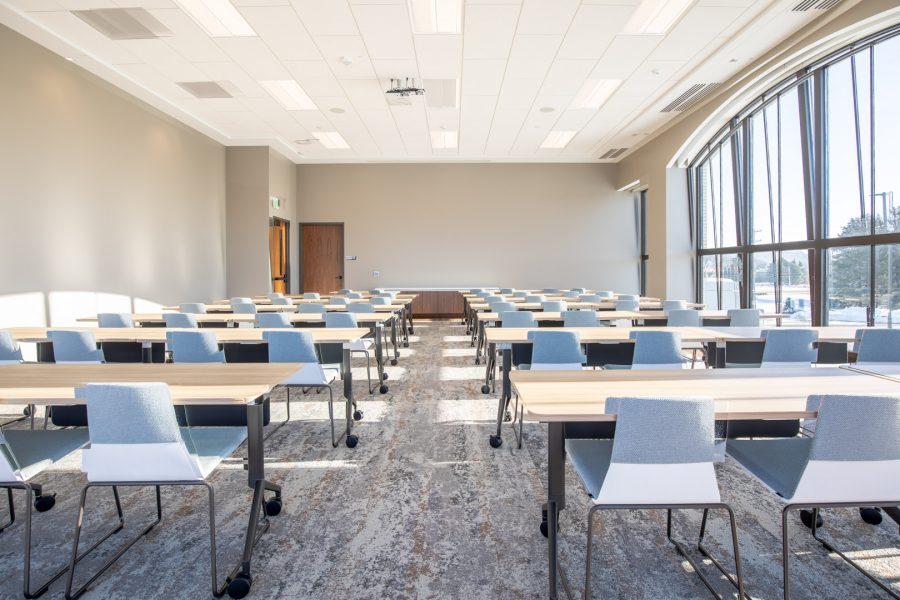 Large modern classroom with long tables and chairs