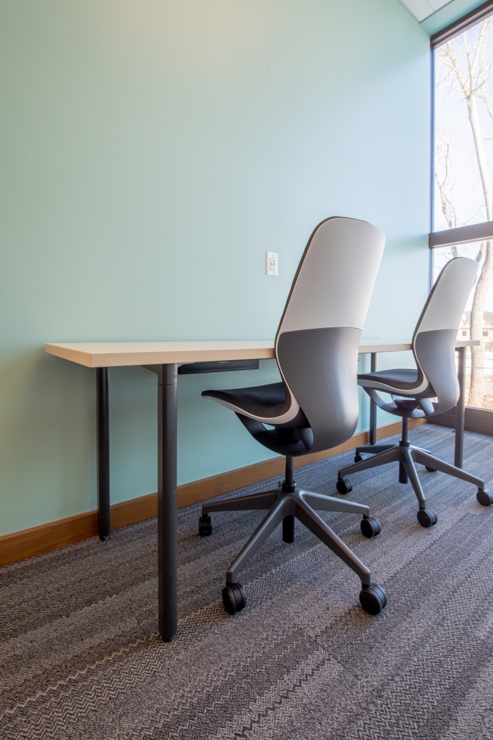 Two desks and chairs in a library